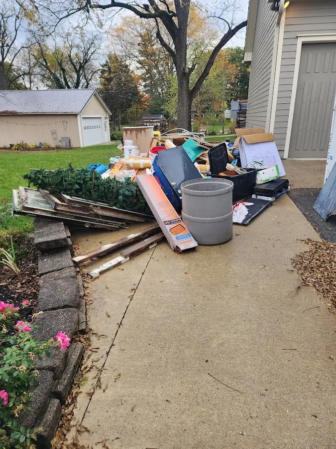 Dumpster being loaded with debris for 12 Yard Dumpster Rental in Midland